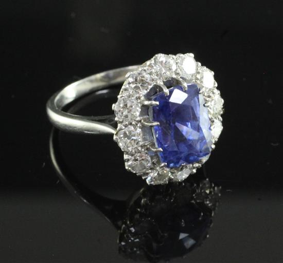 A platinum, sapphire and diamond oval cluster ring, size M.